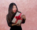 portrait of young happy and excited beautiful Asian Korean woman receiving a romantic anniversary gift box holding the r Royalty Free Stock Photo