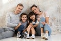 Portrait of young happy family with kids hugging