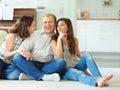 Portrait of young happy family with pretty teenager daughter having fun together at home Royalty Free Stock Photo