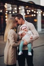 Portrait of family standing together in cosiness atmosphere.