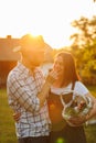 Portrait of young happy farmer couple holding basket with fresh organic vegetables on their rancho at the sunset Royalty Free Stock Photo