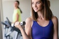 Portrait of a young happy fit woman with dumbbells Royalty Free Stock Photo