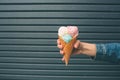 Portrait of young happy girl eating ice-cream, outdoor, over blue wall background Royalty Free Stock Photo