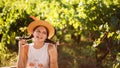 Portrait of young happy girl with straw hat on green blurred vyneyardand background. Teenager enjoying summer life Royalty Free Stock Photo