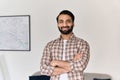 Portrait of young happy indian man looking at camera at home office. Royalty Free Stock Photo