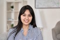 Portrait of young happy indian woman looking at camera at home office.