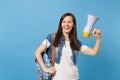 Portrait of young happy joyful attractive woman student in denim clothes with backpack holding electronic megaphone Royalty Free Stock Photo