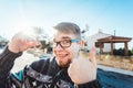 Portrait of a young happy man holding out new house key and gesturing thumbs up Royalty Free Stock Photo