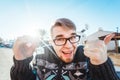 Portrait of a young happy man holding out new house key and gesturing thumbs up Royalty Free Stock Photo