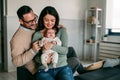 Portrait of young happy man and woman holding newborn cute baby. Happy family concept Royalty Free Stock Photo
