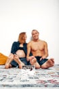 Portrait of young happy married couple hold ultrasound picture. Cheerful family and ultrasound scan photo. Concept of