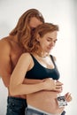 Portrait of young happy married couple hold ultrasound picture. Cheerful family and ultrasound scan photo. Concept of