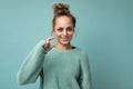 Portrait of young happy positive beautiful blonde woman with sincere emotions wearing casual blue pullover isolated on Royalty Free Stock Photo