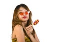 Portrait of young happy and Asian Korean girl in cool fashion sunglasses eating lollipop candy posing naughty teasing Royalty Free Stock Photo