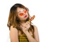 Portrait of young happy and Asian Korean girl in cool fashion sunglasses eating lollipop candy posing naughty teasing Royalty Free Stock Photo