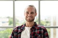 Portrait of young happy short stylish bearded caucasian man or creative designer smiling and looking at camera