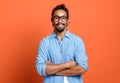 Portrait of young happy smiling african american man in with crossed arms expressing positiveness