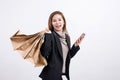 Portrait of young happy smiling Asian woman with shopping bags and smart phone Royalty Free Stock Photo