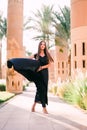 Portrait of young happy smiling beautiful elegant woman in black dress walking at sunny day outdoors Royalty Free Stock Photo