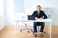 Portrait of young happy smiling business man with laptop Royalty Free Stock Photo