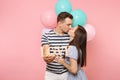 Portrait of young happy kissing couple in love. Woman lean on one`s man chest celebrating birthday holiday party on Royalty Free Stock Photo