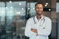 Portrait of young happy and smiling doctor, man in medical coat and stethoscope smiling and looking at camera, Arab Royalty Free Stock Photo