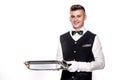 Portrait of young happy smiling waiter with on tray isolated on Royalty Free Stock Photo