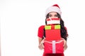 Portrait of casual young happy smiling woman wear in red dress and santa hat hold red to much gift boxes isolated on white backgro Royalty Free Stock Photo