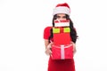 Portrait of casual young happy smiling woman wear in red dress and santa hat hold red to much gift boxes isolated on white backgro Royalty Free Stock Photo