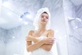 Portrait of young happy smiling woman standing in the bath in white towels wrapped around her head and body after Royalty Free Stock Photo