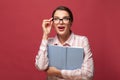 Portrait young happy surprised woman in glasses holds book. Reading, education, studying and learning knowledge concept. Royalty Free Stock Photo