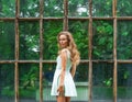 Young happy woman against the background of a botanical garden Royalty Free Stock Photo