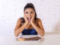 Portrait of young happy woman eating delighted chocolate bar and donuts Royalty Free Stock Photo