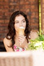 Portrait of young happy woman eating ice-cream Royalty Free Stock Photo