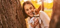 Portrait of young happy woman holding little cute dog Royalty Free Stock Photo