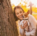 Portrait of young happy woman holding little cute dog Royalty Free Stock Photo