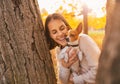 Portrait of young happy woman holding little cute dog Royalty Free Stock Photo