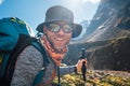 Portrait Young hiker backpacker man in sunglasses smiling at camera in Makalu Barun Park route during high altitude Royalty Free Stock Photo