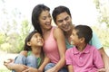 Portrait Of Young Hispanic Family In Park