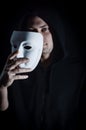 Portrait of a young hooded man taking off his mask, concept for being true and authentic Royalty Free Stock Photo