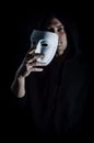 Portrait of a young hooded man taking off his mask, concept for being true and authentic Royalty Free Stock Photo