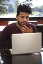 Portrait of young, hopeful Asian man in work. Young businesssman is working in a cafeteria. Business From coffee shop