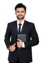 Portrait of a young Indian businessman smiling while holding a diary and pen Royalty Free Stock Photo