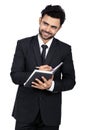 Portrait of a young Indian businessman smiling while holding a diary and pen Royalty Free Stock Photo