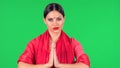 Portrait of young Indian girl with red bindi dot in national classic red sari looking straight. Brunette with long hair Royalty Free Stock Photo