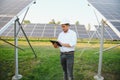 Portrait of a young Indian male engineer or architect at a solar panel farm. The concept of clean energy Royalty Free Stock Photo