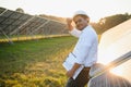 Portrait of a young Indian male engineer or architect at a solar panel farm. The concept of clean energy Royalty Free Stock Photo