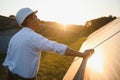 Portrait of a young Indian male engineer or architect at a solar panel farm. The concept of clean energy Royalty Free Stock Photo