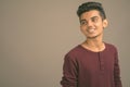 Portrait of young Indian man against gray background Royalty Free Stock Photo