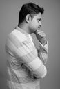 Portrait of young Indian man against gray background Royalty Free Stock Photo